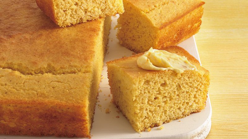 "Photo of a fresh golden loaf of cornbread on a wooden table. Its dense texture and rich color reflect its nutritional and natural benefits. Cornbread is a healthy, gluten-free option that adds a traditional touch to meals with distinctive flavor and multiple health benefits.