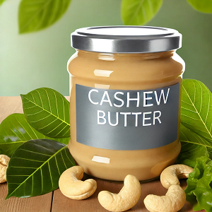 A visually appealing image featuring a larger jar labeled 'Cashew Butter,' surrounded by fresh cashew nuts and vibrant green leaves. The jar is placed on a wooden surface with a clean, softly lit background, emphasizing the natural and wholesome qualities of cashew butter